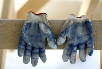 Used old dirty torn worker's gloves as a metaphor, concept or symbol for the end of the work season