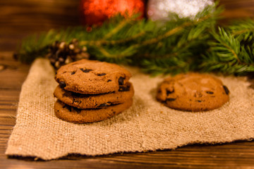 Chocolate chip cookies and christmas decorations on a wooden table