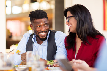 happy couple eating at restaurant