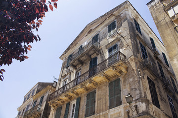 Obraz premium Old, historical buildings in Corfu (Kerkyra) town. It's an island of Greece’s northwest coast in the Ionian Sea. Cultural heritage reflects years spent under Venetian, French and British rule.