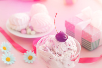 ice cream in a Cup next to the marshmallows, flowers, pink sweets