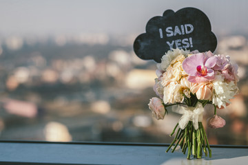 Bridal bouquet and I Said Yes sign