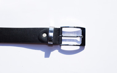 A leather men's belt on colored background