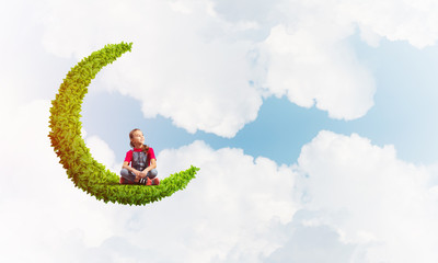 Concept of careless happy childhood with girl dreaming about something