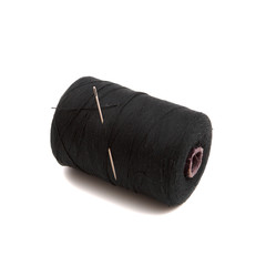 Spool of black thread and needle on white background