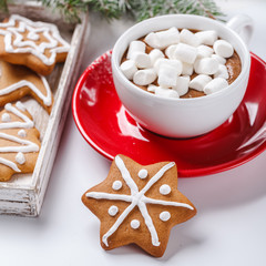 Christmas cookies in a white wooden box with hot chocolate and marshmelow, on a light background.