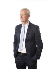 Senior professional man standing against white background 