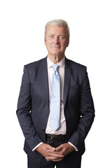 Senior professional man standing against white background 
