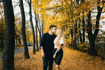 Young couple having fun in the autumn forest