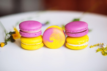 Symbol heart of flowers and macaroons on the light background. Top view. Text I love you