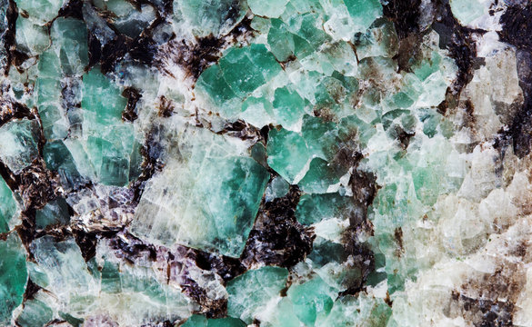 Malachite in mica group of sheet silicate minerals. Natural decorative stone texture pattern macro view.