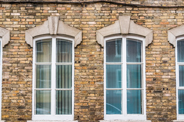 Fototapeta na wymiar Old european brick building with windows in Quebec, Canada