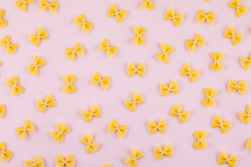 Pattern made of pasta on pink background. Flat lay. Minimal concept