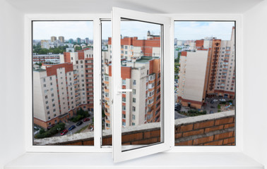 View through the pvc window frame on balcony on high floor at multi-apartment building