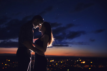 Lovers. A couple of people in the background of stars, the night sky. Concept love.
