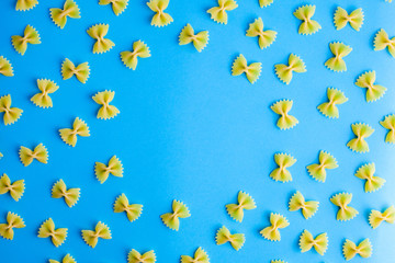 Pattern made of pasta on blue background. Flat lay. Minimal concept