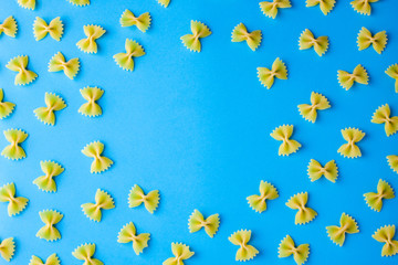 Pattern made of pasta on blue background. Flat lay. Minimal concept