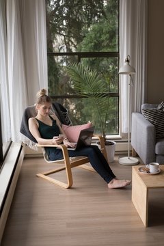 High angle view of young woman using technologies while sitting