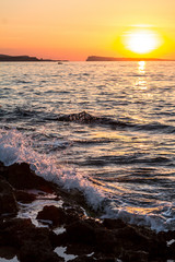 Water splash in the sea at sunset