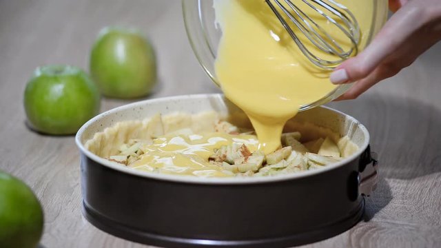 A woman in the kitchen cooking Apple pie