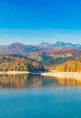      Panoramic view of Lokvarsko lake with Risnjak mountain in background, beautiful colorful mountain autumn landscape, Lokve, Gorski kotar, Croatia 