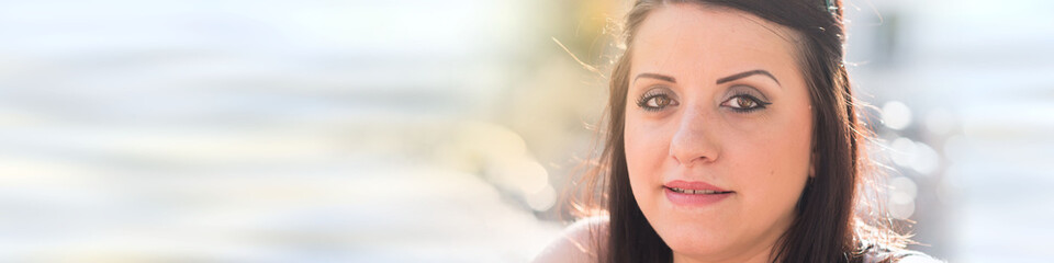 Fototapeta premium Portrait of pretty young woman looking at the camera