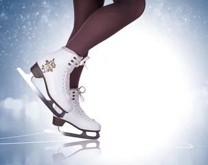 Tuinposter Woman legs in ice skating boots © Soloviova Liudmyla