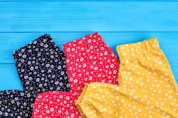 Trendy natural baby trousers close up. Organic pants in vintage print for baby girls lying on...