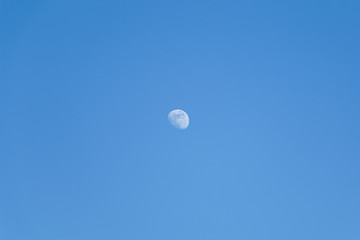 The shape of the moon on a blue sky day