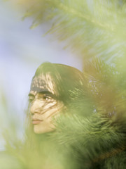 Portrait of a young woman shot through the pines