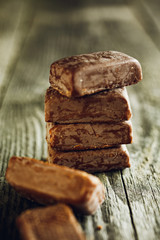 Pile of chocolate pieces on wooden background