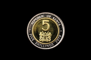 A super macro image of a Kenyan five shilling coin isolated on a black background