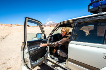 Salar de Uyuni in Bolivia with car. Girl drive a car
