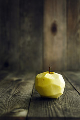 Peeled Apple on wooden background
