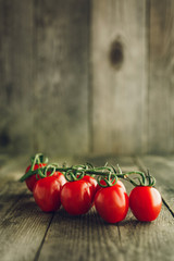 Cherry tomatoes on wooden background