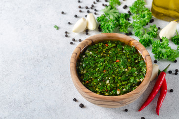 Traditional argentinian chimichurri sauce made of parsley, cilantro, garlic and chili pepper in a...