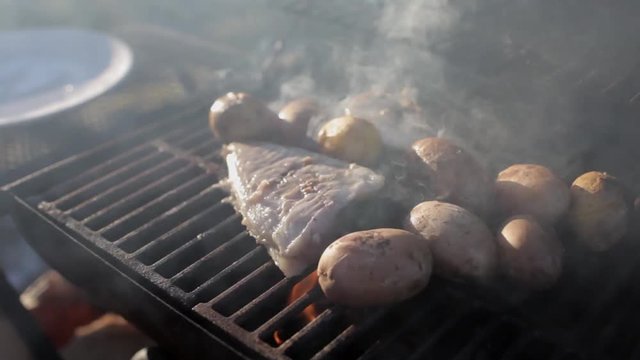 fish with potatoes cook on the grill
