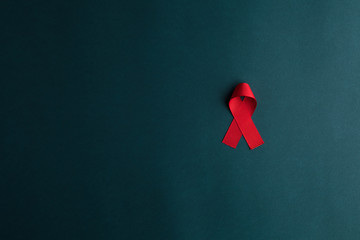 aids red ribbon on blue background, hiv ribbon