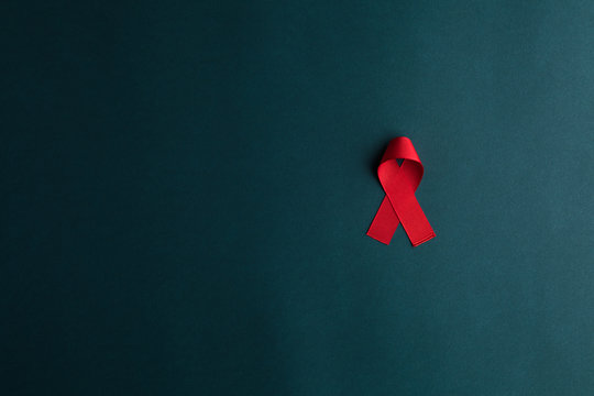 aids red ribbon on blue background, hiv ribbon