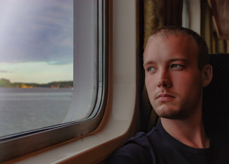 Fototapeta premium European man relaxing and looking out of a window