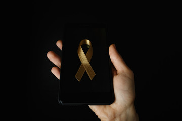 gold ribbon symbol of the fight against cancer in children