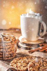 Winter autumn still life  homemade recipe honey ginger oatmeal cookie and bagel, cocoa cup coffee with marshmallow on wooden table kitchen