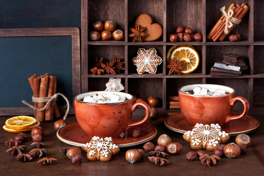 Composition with mugs of  hot chocolate and spices on wooden table
