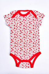 Infant girl white and red bodysuit. Baby-girl white cotton bodysuit wih a pattern of small red frowers isolated on white background.