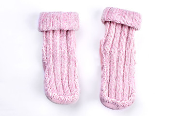 Couple of wool knitted pink socks. Pair of natural wool knitted socks on white background. Soft handmade winter socks for kids.