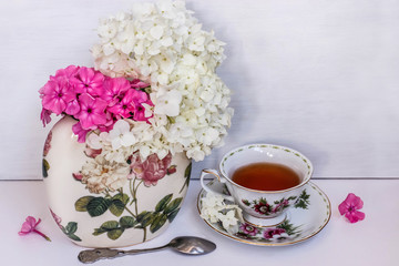 bright, country still life with Phlox and black tea