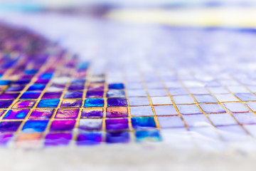 Abstract bokeh background of colorful purple tiles in water fountain