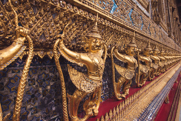 Obraz premium The statue garuda fairy tale animal of thai buddhist, in the temple wall, at Wat Prakeaw temple, in Bangkok, Thailand 