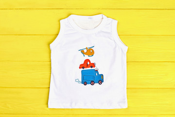 Baby boy white sleeveless t-shirt. Infant boy white cartoon t-shirt on yellow summer background. Kids summer outfit on sale.