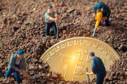 macro miner figurines digging ground to uncover big shiny bitcoin